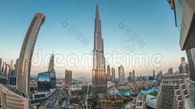 日落后迪拜市区的全景式天际线景观，商场、喷泉和摩天大楼在白天到夜间空中盘旋