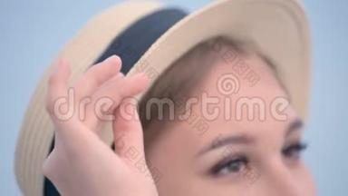 一个漂亮的白种人年轻女子戴着一顶草帽、扎着辫子的<strong>大特写</strong>肖像，使帽子挺直