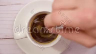<strong>用勺子</strong>手搅拌咖啡。 一杯热黑咖啡回家制作