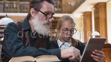 聪明的胡子老爷爷戴着眼镜，和他迷人的小孙女坐在图书馆里，