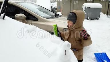 4k视频3岁幼儿男孩帮助清洁车覆盖雪后暴风雪