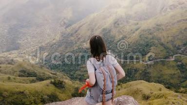 在斯里兰卡令人叹为观止的山景中，背高角度观看快乐的旅游妇女与背包触摸头发。