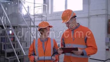 工厂专家女孩带着戴着平板电脑头盔的男人正在检查生产，同时讨论<strong>质量问题</strong>