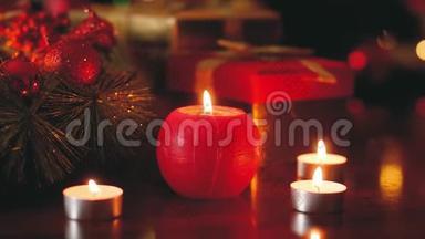 为<strong>圣诞</strong>前<strong>夜</strong>装饰的木桌上燃烧蜡烛的特写镜头。 完美的背景或背景