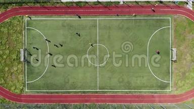 顶部的空中景观。 孩子们通过在一个小足球场上踢足球来进球。