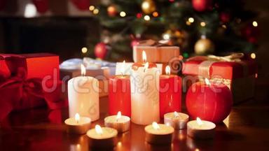 4k特写视频，在木桌上放蜡烛和圣诞礼物，放在圣诞树上