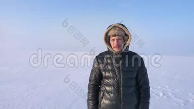 放大了中年探险家的镜头，冷静而严肃地看着雪漠背景下的远程摄像机。