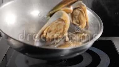 餐厅食物烹饪。 慢动作食物视频.. 厨师烹饪或在煎锅中品尝海鲜。 溅出来的油。 高清高清