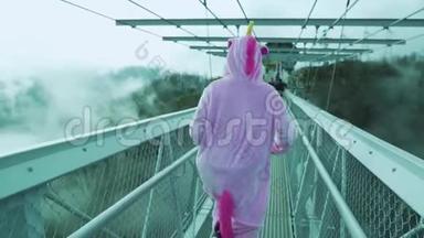 独角兽服装女孩在现代金属桥上弹跳。 极限运动，在索契休息.. 天公园索契。