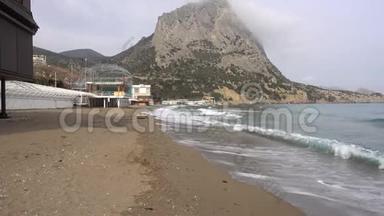 海浪在黑海废弃的鹅卵石海岸上流动。 克里米亚的诺维·斯维村<strong>阴云密布</strong>的春日