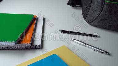 学生少年在白桌子上收集一个灰色的书包上学