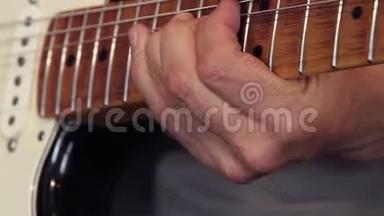 吉他手的特写`他的手放在吉他<strong>弹拨</strong>板上，展示如何正确地做弯曲和颤音技术