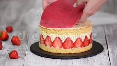 草莓碎蛋糕。 糕点厨师把杏仁饼放在蛋糕上。