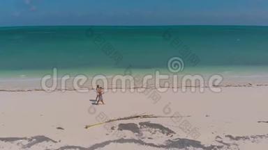 在菲律宾，一对旅伴在蔚蓝的沙滩上漫步