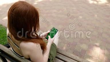 公园里的女孩在社交网络上交流，阳光明媚的长凳上