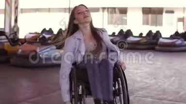 残疾残疾的残疾青年妇女坐轮椅在电动汽车的吸引面上跳舞