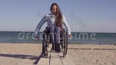 轮椅上的年轻残疾妇女在春季或春季在靠近海边的木制坡道旁为残疾人移动