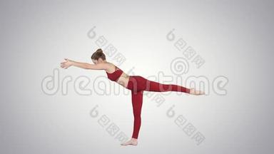 图拉丹达萨纳或平衡棍球是一种高级瑜伽姿势，由美丽的瑜伽女人在梯度背景。