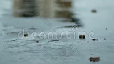 雨滴滴落在潮湿的水泥地上。 硬雨滴，溅在水泥地面上..