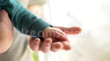 牵着手。 把熟睡的宝宝交给爸爸特写的手.. 双手与白色背景隔离