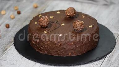 巧克力榛子摩丝蛋糕覆盖巧克力釉，装饰巧克力元素，木制背景。