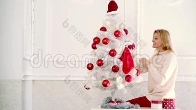 用红球<strong>装饰圣诞树</strong>。 假日和人的概念-快乐妈妈在家<strong>装饰圣诞树</strong>