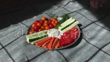 黄瓜、胡椒、胡萝卜、<strong>青菜</strong>、樱桃西红柿等<strong>切</strong>好的蔬菜放在盘子的中间