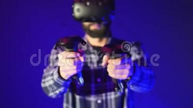 <strong>虚拟</strong>现实控制器的特写，<strong>拍摄</strong>在一个射击<strong>虚拟</strong>现实游戏。 穿着蓝色背景VR耳机的男人