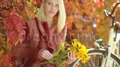 有黄色浮子的女人。 秋天快乐的女孩和快乐。 秋天在公园散步的美丽快乐女孩的户外画像