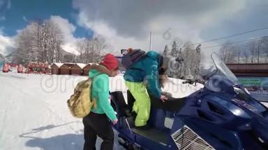 朋友们在滑雪场玩得很开心。 微笑的年轻人骑着<strong>雪地</strong>摩托。 三个人在<strong>雪地</strong>摩托上享受