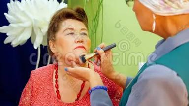 化妆师正在给老太太化妆。