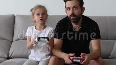 年轻的父亲和女儿<strong>玩</strong>电子游戏，庆祝胜利。 <strong>嗨</strong>，五岁