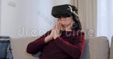 幸福而微笑的老妇人一边戴着虚拟现实的眼镜，坐在沙发上，对此她印象深刻
