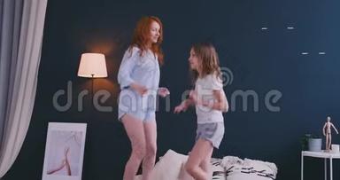 可爱的<strong>小女孩</strong>和她可爱的母亲一起玩，<strong>跳舞</strong>，现代风格，一起跳，在床上给高五。