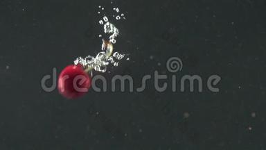 红色的樱桃在黑色的背景上溅入水中。 掉在水里的新鲜浆果。 有机浆果，健康食品，饮食