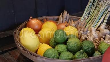 篮子里有水果和蔬菜。 在靠近木墙的地板上放置各种柠檬和蔬菜的编织篮子