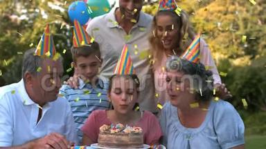 三代家庭在户外庆祝生日