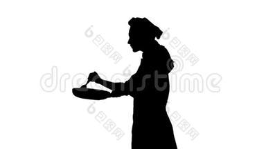 厨师女士用勺子搅拌食物的黑色轮廓。