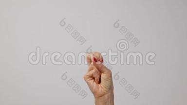 女人举起两个手指，表示和平或胜利的象征或字母V。女人一只手举起两个手指