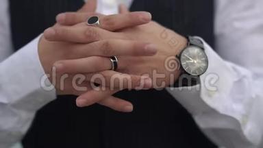 交叉的手指紧贴着古典西装上的时髦男人。 时髦的手表在大老板的手上。