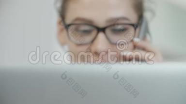 十几岁的女孩在社交网络上用笔记本电脑和手机聊天，微笑着