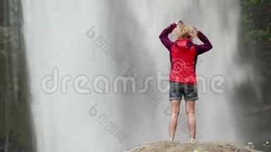 穿红色夹克的女人在<strong>大瀑布</strong>附近