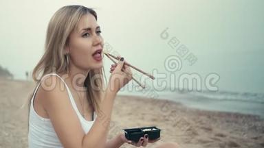 一个年轻的白种人女孩用日本筷子把生姜放进嘴里。 嚼了之后，玩得开心