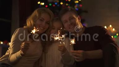 欢乐的家庭与孟加拉灯寻找相机，享受神奇的圣诞节
