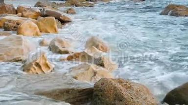 巨大的海浪撞击岩石，近距离观看。 海浪飞溅，岩石海岸产生泡沫