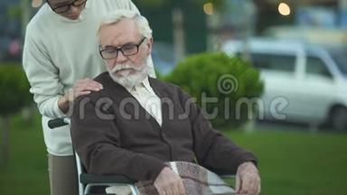 坐在轮椅上的老人，孙女安慰他，家人支持