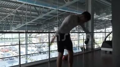 一个年轻的亚洲人正在跆拳道健身房训练。 热身