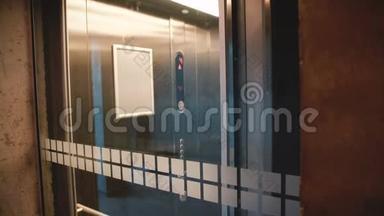 透明<strong>电梯</strong>到达楼层，年轻强调严肃的欧洲男子进入和<strong>乘坐</strong>，通过玻璃墙观看。