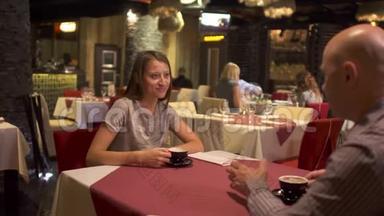 可爱的成年夫妇在餐厅约会，喝咖啡