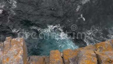 海浪和橙色岩石悬崖，俯视，倾斜